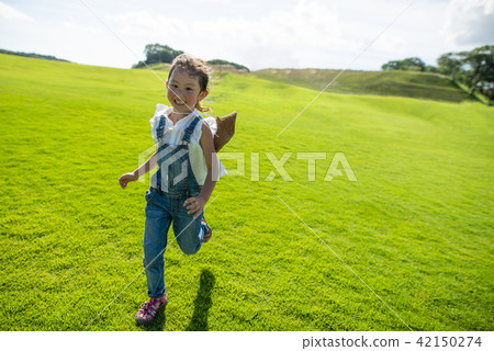 Girls running in the meadow 42150274