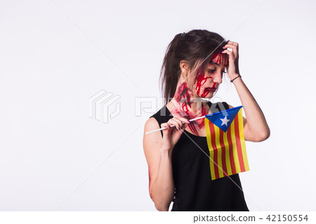 The victim woman holds the flag of Catalonia on white background with copyspace. Protest against 42150554