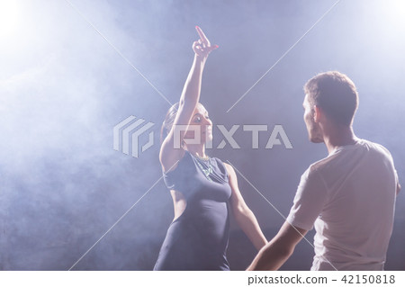 Active happy adults dancing bachata together in dance class 42150818