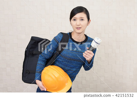 A woman who is evacuated by a disaster prevention helmet A woman who is evacuated by a disaster prevention helmet 42151532