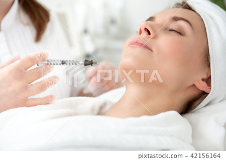Glad woman getting injection in check Glad woman getting injection in check 42156164