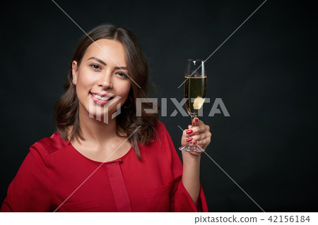 Woman with glass of champagne Woman with glass of champagne 42156184