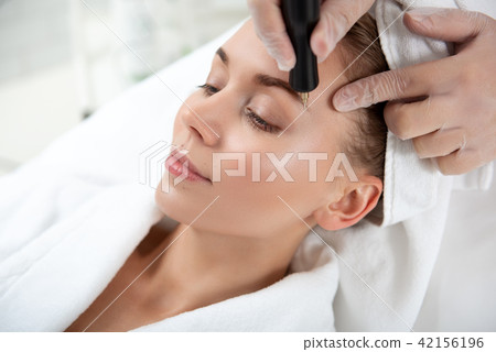 Thoughtful female during cosmetology service 42156196