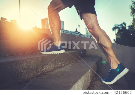 Athlete training on street in morning  42156603