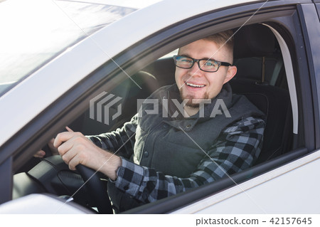 Attractive happy man in good white car Attractive happy man in good white car 42157645