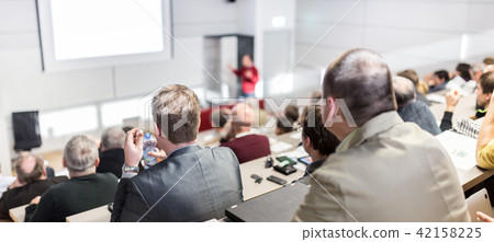 Business speaker giving a talk at business conference event. 42158225