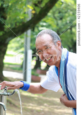 Senior water supply in summer park Senior water supply in summer park 42159406