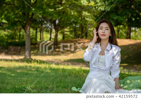Woman resting in the shade of a tree 42159572