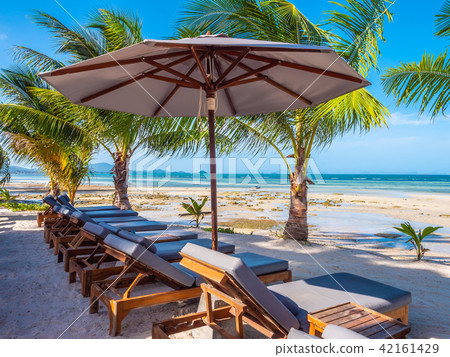 Umbrella and chair on the beach and sea ocean with blue sky Umbrella and chair on the beach and sea ocean with blue sky 42161429
