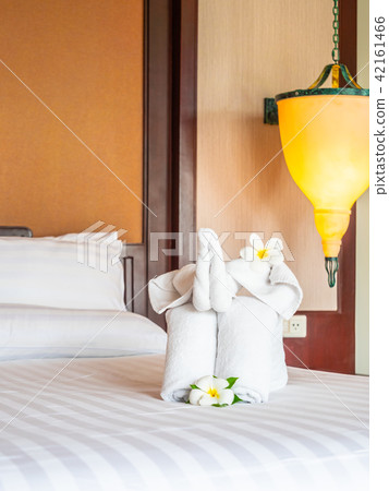 White elephant towel and comfortable pillow on bed White elephant towel and comfortable pillow on bed 42161466