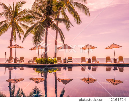Umbrella and chair around luxury outdoor swimming pool Umbrella and chair around luxury outdoor swimming pool 42161724