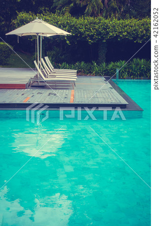 Beautiful luxury umbrella and chair around swimming pool in hotel and resort 42162052