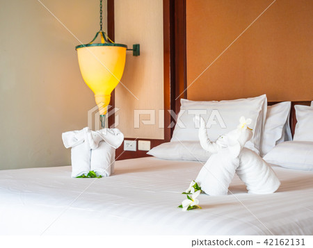 White elephant towel and comfortable pillow on bed White elephant towel and comfortable pillow on bed 42162131