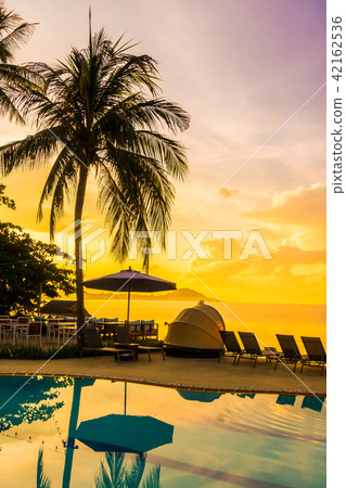 Beautiful outdoor view with umbrella and chair around swimming pool in luxury hotel and resort Beautiful outdoor view with umbrella and chair around swimming pool in luxury hotel and resort 42162536