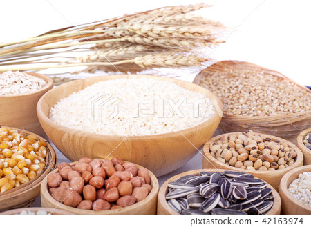 Cereal grains , seeds, beans on wooden background Cereal grains , seeds, beans on wooden background 42163974