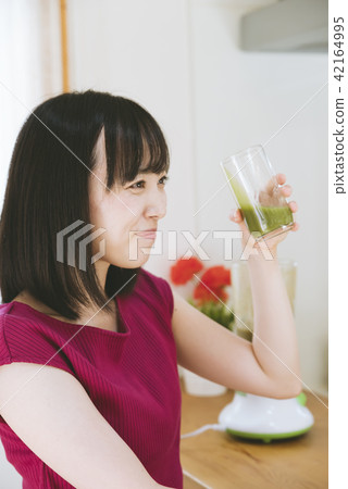 A woman making a smoothie 42164995