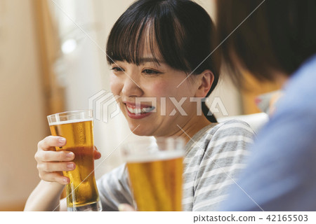 A woman drinking at home 42165503