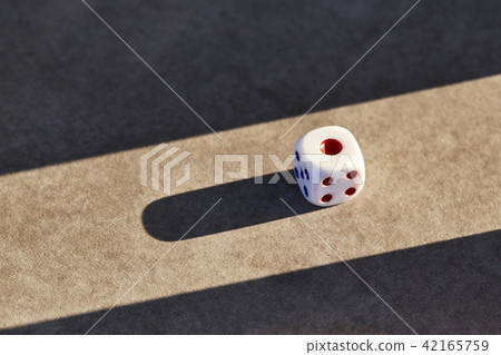 Closeup of a single white dice Closeup of a single white dice 42165759