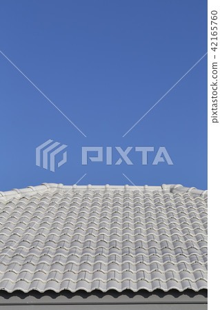 Gray tile roof against the blue sky Gray tile roof against the blue sky 42165760