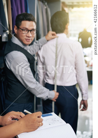 Tailor working with client Tailor working with client 42166612