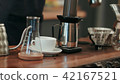 Barista pouring water on coffee ground with filter 42167521