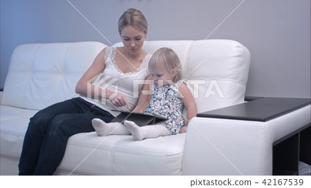 Mother and baby using digital tablet Mother and baby using digital tablet 42167539