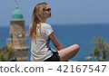 Young woman in sunglasses enjoying the sea view during vacation 42167547