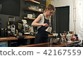 A jug of water adds to a professional filter to make a traditional hot coffee extract in a filter in 42167559