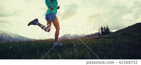 woman running on beautiful green mountain hill woman running on beautiful green mountain hill 42168752
