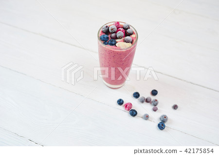 Glass of pink fruit smoothies milkshake or cocktail on white background, breakfast vegan and raw 42175854