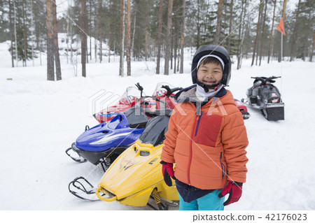 Snowmobile and children snow scene Snowmobile and children snow scene 42176023