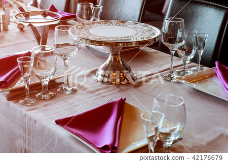 Beautiful table setting with crockery and flowers Beautiful table setting with crockery and flowers 42176679