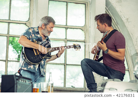 Repetition of rock music band. Electric guitar players Repetition of rock music band. Electric guitar players 42176831