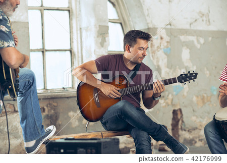 Repetition of rock music band. Electric guitar player and drummer behind the drum set. Repetition of rock music band. Electric guitar player and drummer behind the drum set. 42176999