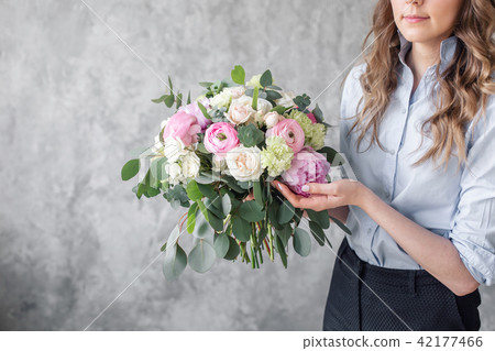 close-up beautiful bouquet in Young Woman hands. florist creating beautiful bouquet in flower shop 42177466