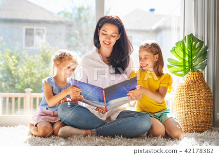mother reading a book mother reading a book 42178382