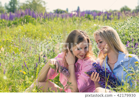 Two friends rest on the field 42179930