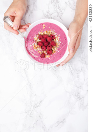 Hands holding smoothie bowl. Hands holding smoothie bowl. 42180829