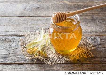 Glass jar of honey, Linden flowers Glass jar of honey, Linden flowers 42181247