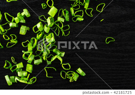 Fresh Raw green spring onion on black wood Fresh Raw green spring onion on black wood 42181725