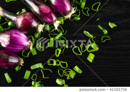 Fresh Raw green spring onion on black wood Fresh Raw green spring onion on black wood 42181730