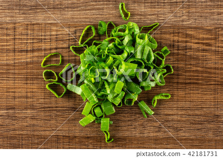Fresh Raw green spring onion on brown wood Fresh Raw green spring onion on brown wood 42181731