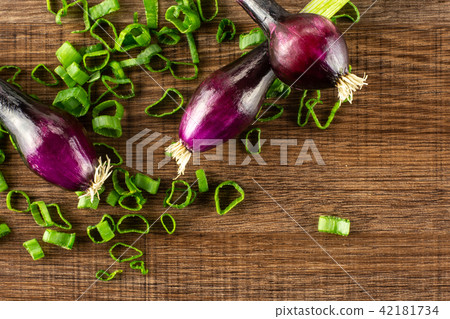 Fresh Raw green spring onion on brown wood Fresh Raw green spring onion on brown wood 42181734