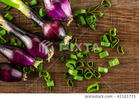 Fresh Raw green spring onion on brown wood Fresh Raw green spring onion on brown wood 42181735