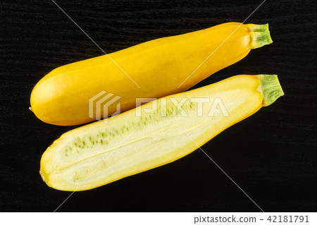 Fresh Raw yellow zucchini on black wood Fresh Raw yellow zucchini on black wood 42181791