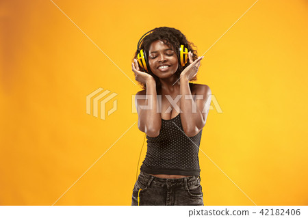 Studio portrait of adorable curly girl happy smiling during photoshoot. Stunning african woman with Studio portrait of adorable curly girl happy smiling during photoshoot. Stunning african woman with 42182406