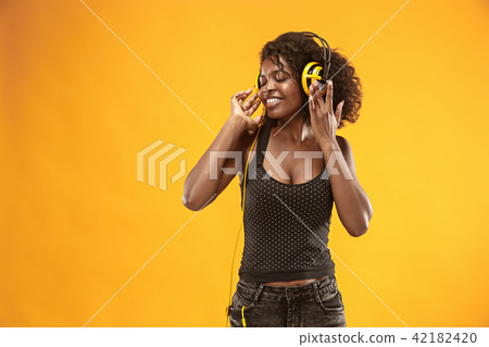 Studio portrait of adorable curly girl happy smiling during photoshoot. Stunning african woman with Studio portrait of adorable curly girl happy smiling during photoshoot. Stunning african woman with 42182420