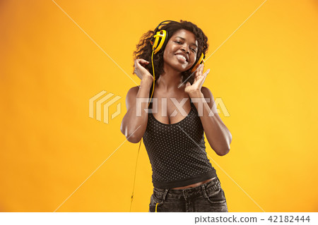 Studio portrait of adorable curly girl happy smiling during photoshoot. Stunning african woman with 42182444