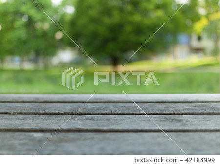 Empty wooden table with blurred city park Empty wooden table with blurred city park 42183999