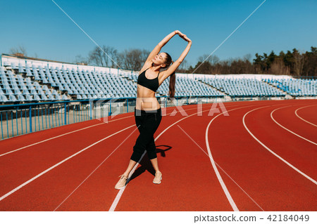 A beautiful sports girl in black sportswear A beautiful sports girl in black sportswear 42184049